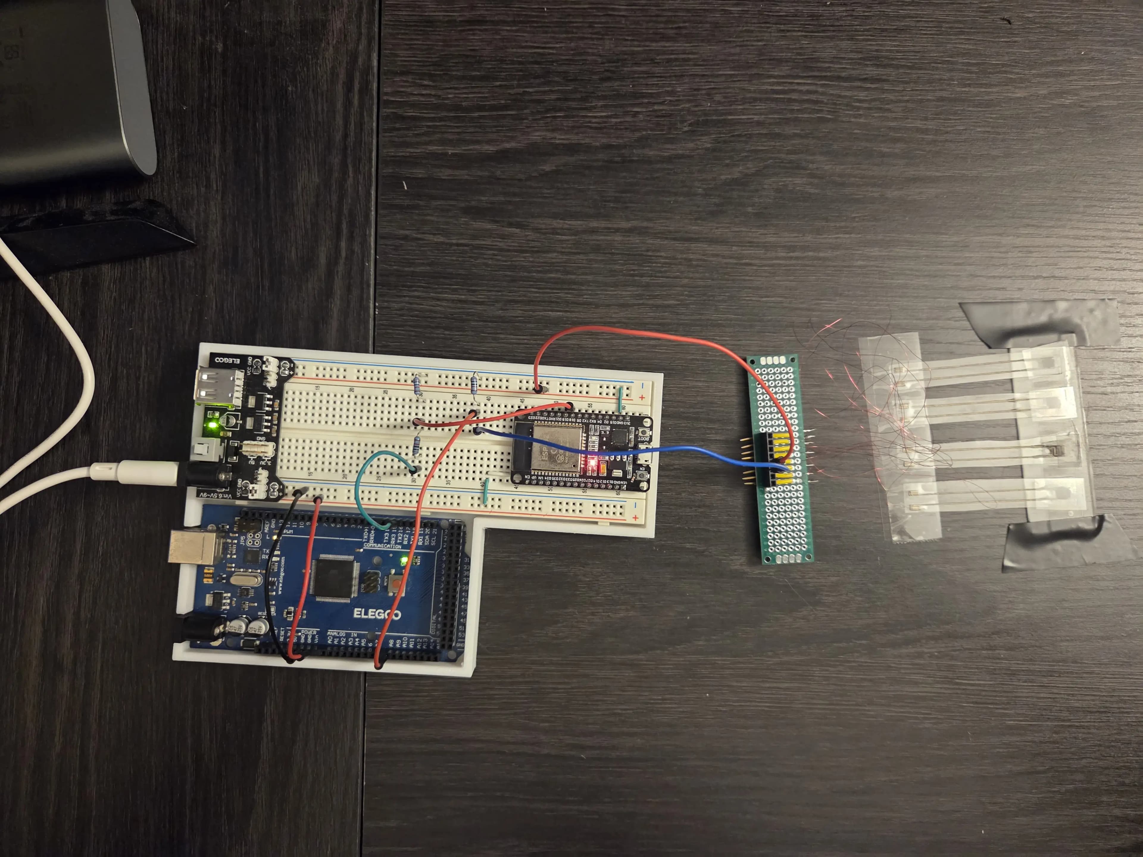Electronics - No Plant Sensor Test Picture of electronics with breadboard, Arduino, ESP32, and force-sensitive resistors.